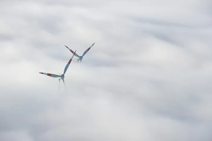 Framed Print : Wind turbines sticking out of the fog