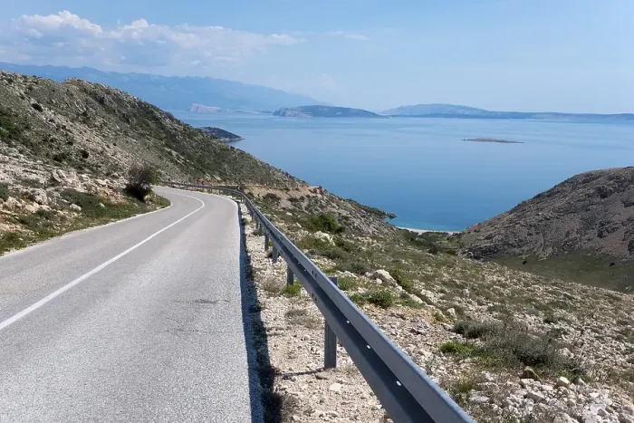 Framed Print : Winding road through mountainous landscape with sea view Framed Print : Winding road through mountainous landscape with sea view