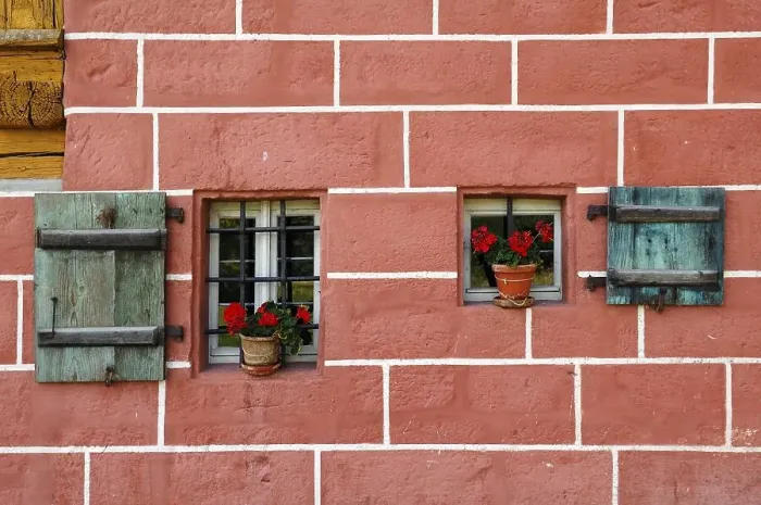 Framed Print : Window with shutters and geraniums on a mill Framed Print : Window with shutters and geraniums on a mill