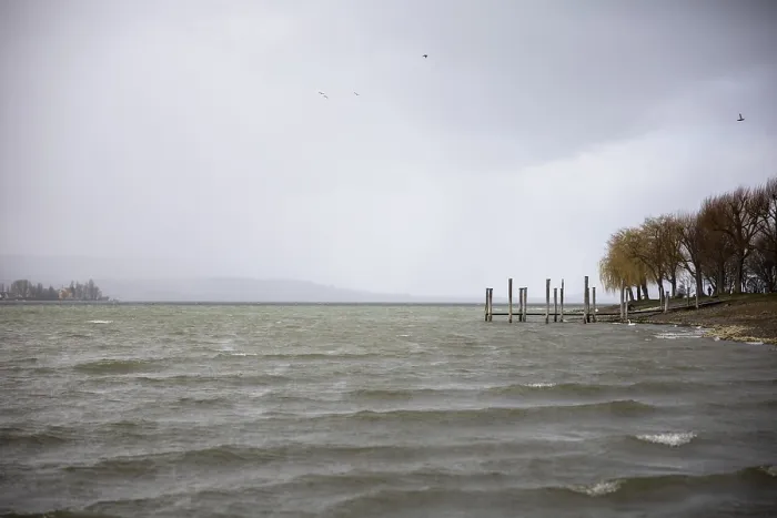 Framed Print : A windy, cloudy seascape with jetty and birds in the sky
