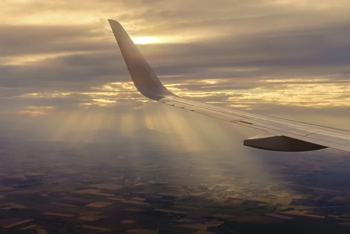 Framed Print : Wing of the plane during the flight with sun rays in the background Framed Print : Wing of the plane during the flight with sun rays in the background