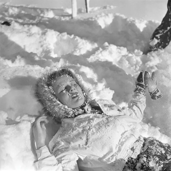 Framed Print : Winter in the 1940s. A young woman is lying in the snow