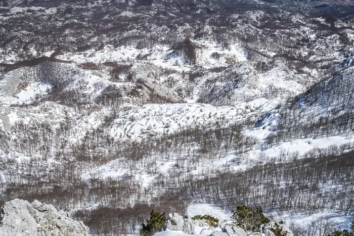 Framed Print : Winter landscape of trees and hills in snow as seen from the top of Mount Lovcen in Lovcen National Park