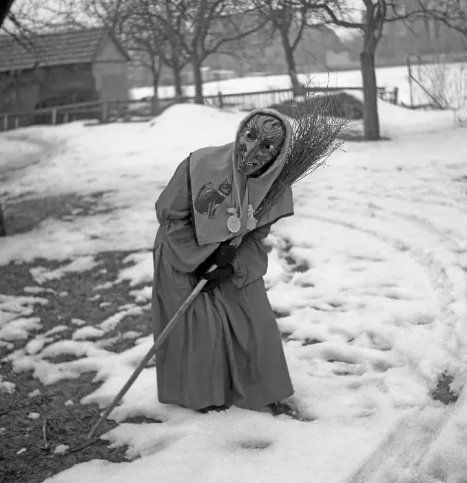 Framed Print : Witch with broom in hand stands in a curvilinear position in the snow Framed Print : Witch with broom in hand stands in a curvilinear position in the snow