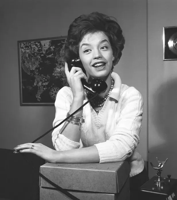 Framed Print : Woman in the 1950s. A young dark-haired woman speaking on the phone. She is the swedish singer Lill-Babs Svensson. 1938-2018. Ref 11-01-9