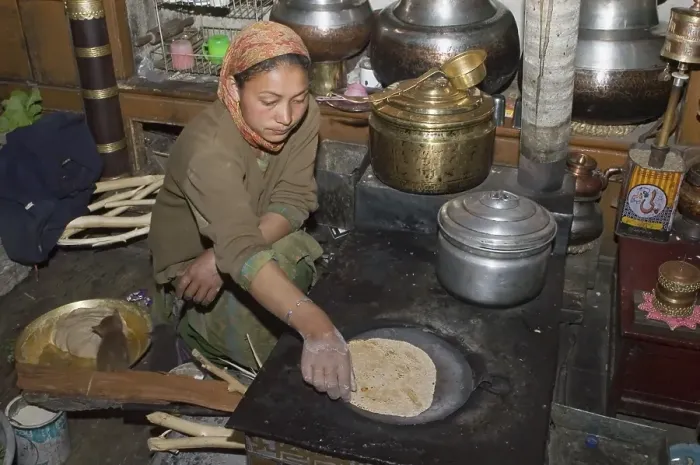 Framed Print : Woman baking chapatis in the kitchen