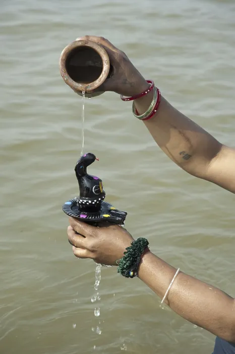 Framed Print : Woman bathing shivling in sangam at uttar pradesh India