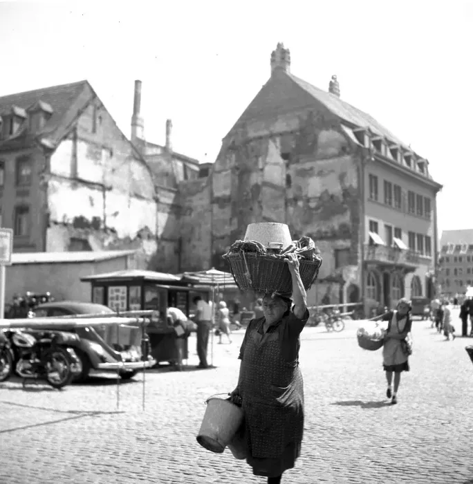 Framed Print : A woman carries a wooden basket on her head