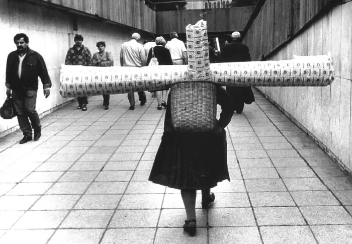 Framed Print : Woman carrying carpet about 1970s
