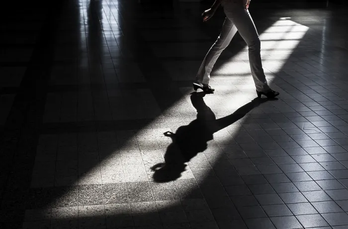 Framed Print : Woman casting a shadow on the floor of a building