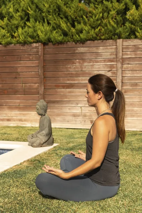 Framed Print : A woman in a casual workout outfit is engaged in the Sukhasana (Easy Pose)