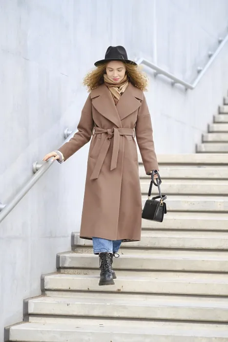 Framed Print : A woman with curly hair is walking down the stairs