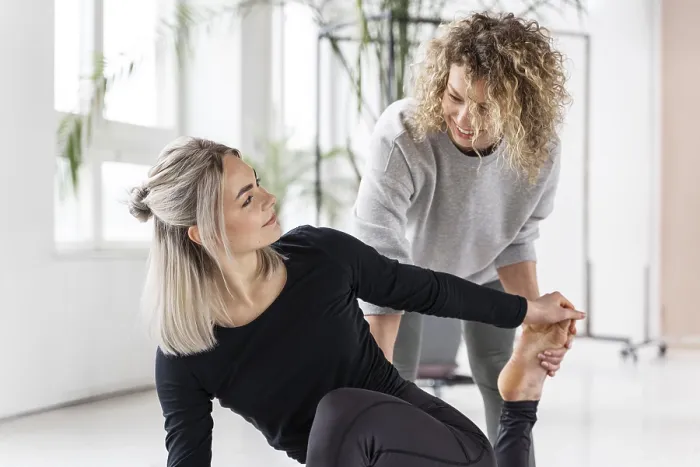 Framed Print : Woman doing yoga with teacher