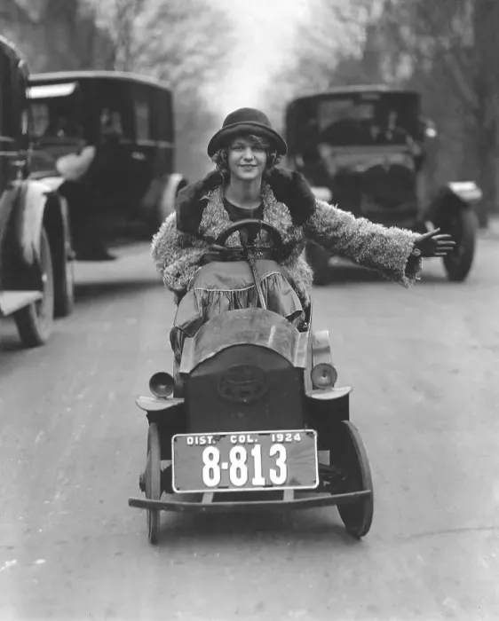 Framed Print : Woman driving in a soapbox on a busy street Framed Print : Woman driving in a soapbox on a busy street