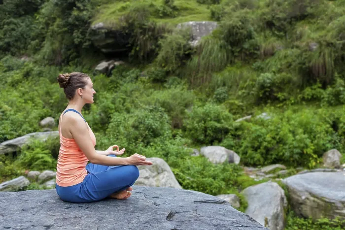 Framed Print : Woman in Hatha yoga asana Padmasana outdoors
