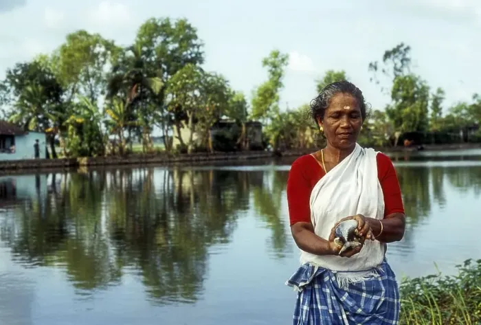 Framed Print : A woman holding freshly caught fish Framed Print : A woman holding freshly caught fish