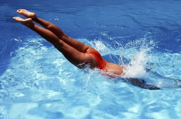 Framed Print : Woman jumps into the water, head dive, immersion