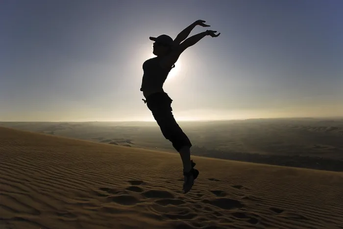 Framed Print : Woman leaping into the air in the desert Framed Print : Woman leaping into the air in the desert
