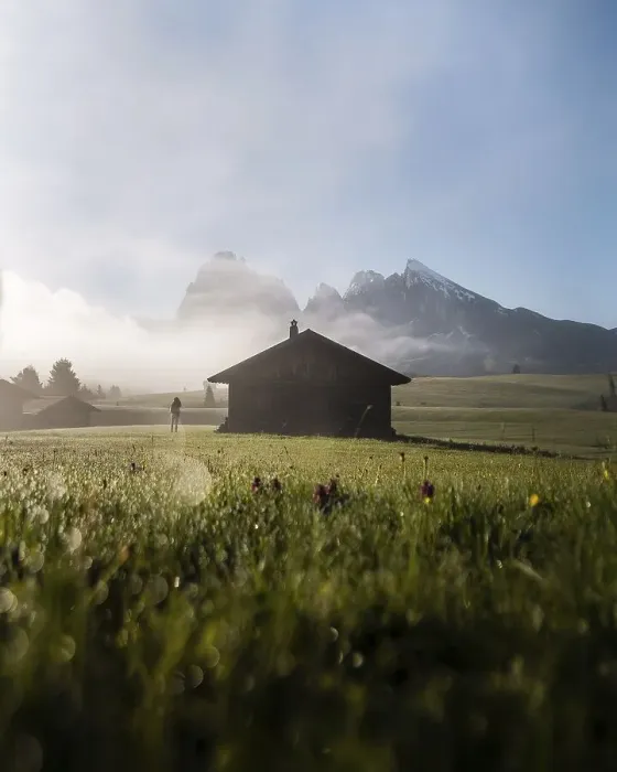 Framed Print : Woman looking on foggy meadow next to hut