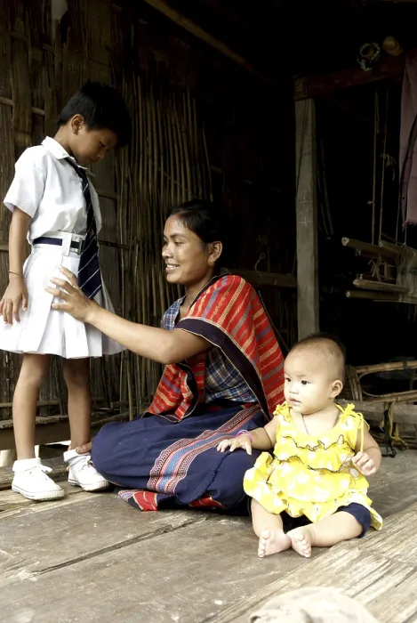 Framed Print : Woman making her child ready for school