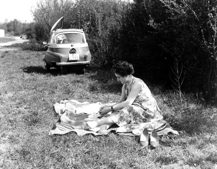 Framed Print : Woman making picnic, in the background an Isetta
