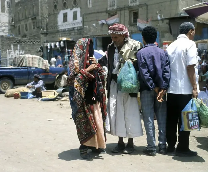 Framed Print : A woman and a man talking in the old town of Sanaa, UNESCO World Heritage Site, Sanaa, Yemen, Asia