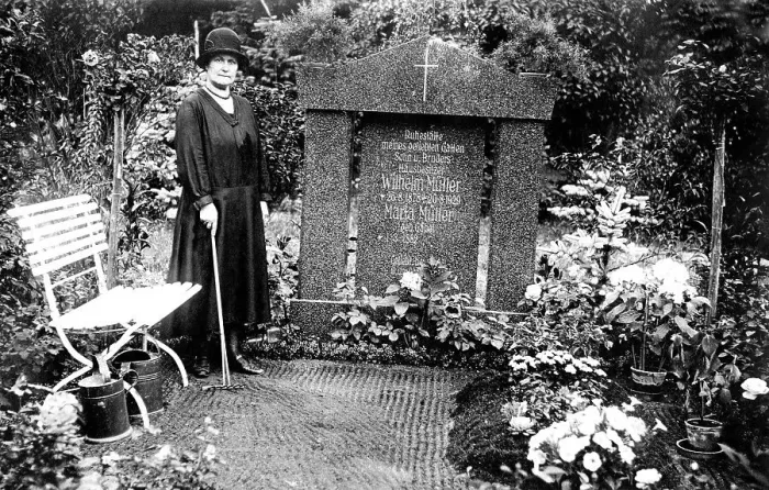 Framed Print : Woman mourning at grave, cemetery