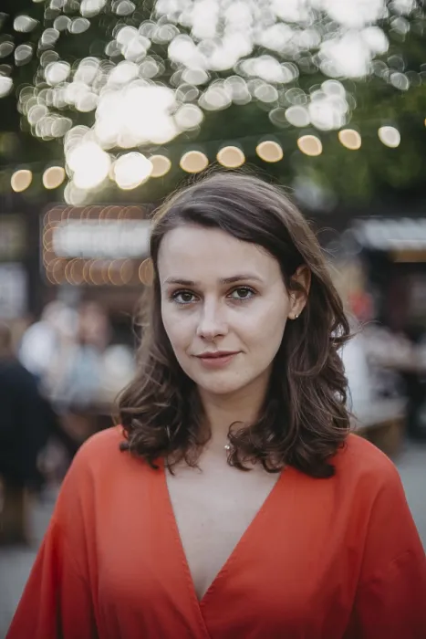 Framed Print : Woman in an orange dress in an outdoor setting with bokeh lights