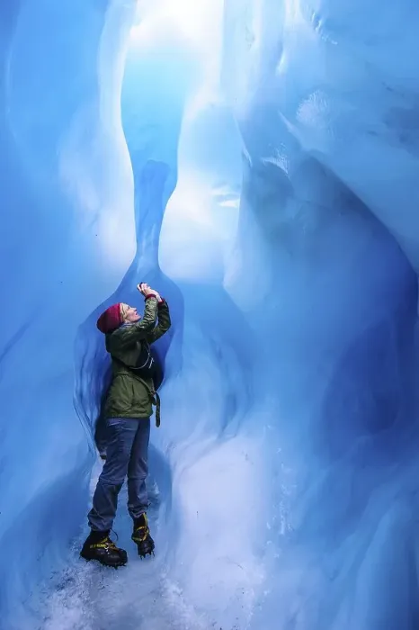 Framed Print : Woman photographing in a ice cave in Fox Glacier Framed Print : Woman photographing in a ice cave in Fox Glacier