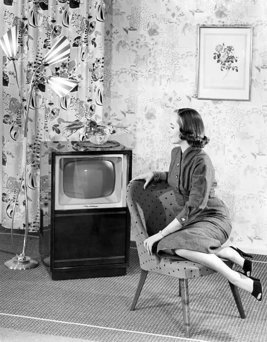 Framed Print : Woman posing next to a television