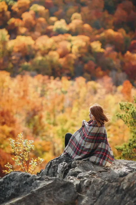 Framed Print : A woman sits on a rocky outcrop