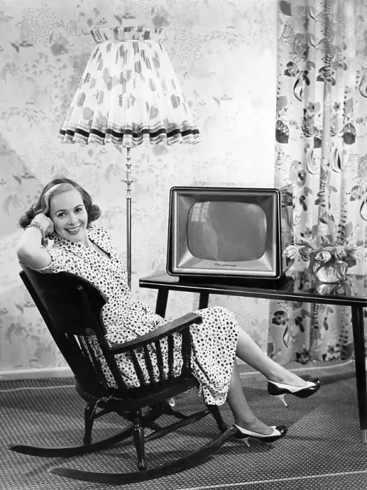 Framed Print : Woman sitting in front of a television in a rocking chair Framed Print : Woman sitting in front of a television in a rocking chair