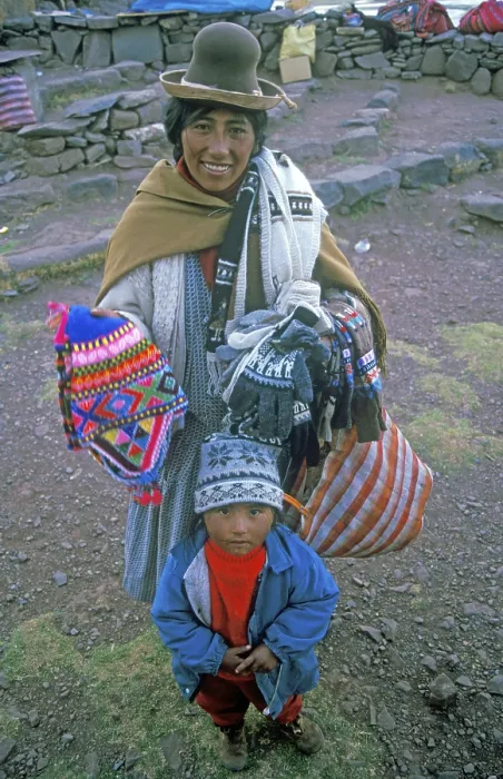 Framed Print : A woman with a small child sells souvenirs to tourists at the Sillustani ruins on Lake Umayo near Puno Framed Print : A woman with a small child sells souvenirs to tourists at the Sillustani ruins on Lake Umayo near Puno