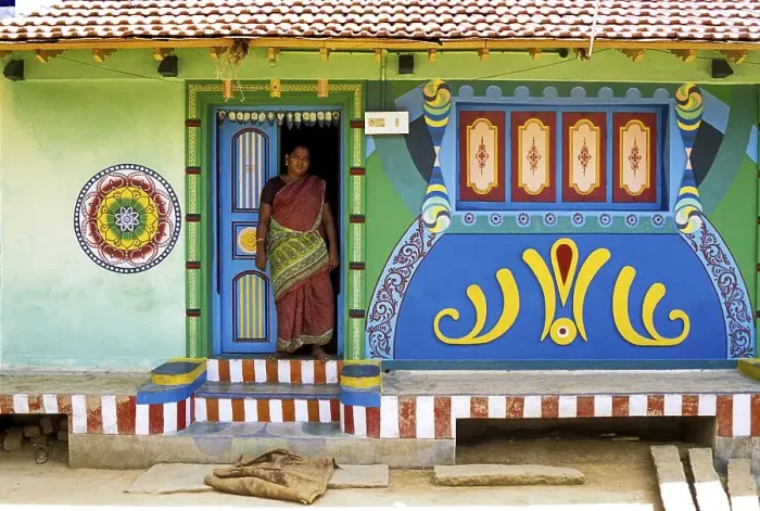 Framed Print : A woman standing at the entrance door of the village house