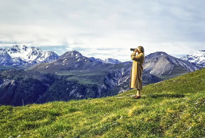 Framed Print : Woman standing on hillside using binoculars in mountains of national park, Western Rhaetian Alps, Switzerland, Europe 1959, Europe