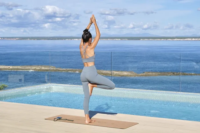 Framed Print : A woman stands in a yoga pose on a rooftop overlooking a serene ocean Framed Print : A woman stands in a yoga pose on a rooftop overlooking a serene ocean