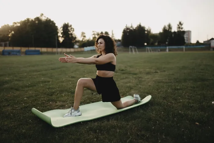 Framed Print : A woman stretches on a yoga mat in a park