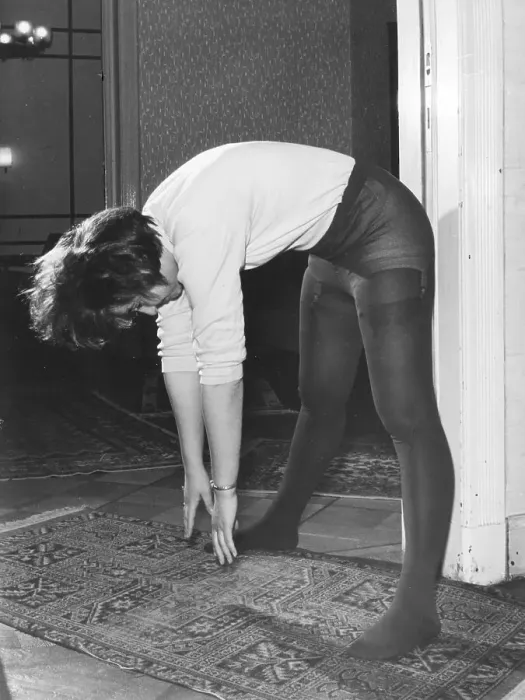 Framed Print : Woman in transparent pantyhose doing stretching exercises