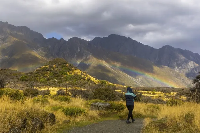 Framed Print : A woman in a winter coat explores the breathtaking autumn landscape of Mount Cook