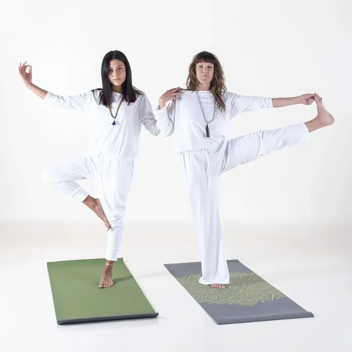 Framed Print : Two women dressed in white doing yoga poses while looking at camera over white background Framed Print : Two women dressed in white doing yoga poses while looking at camera over white background