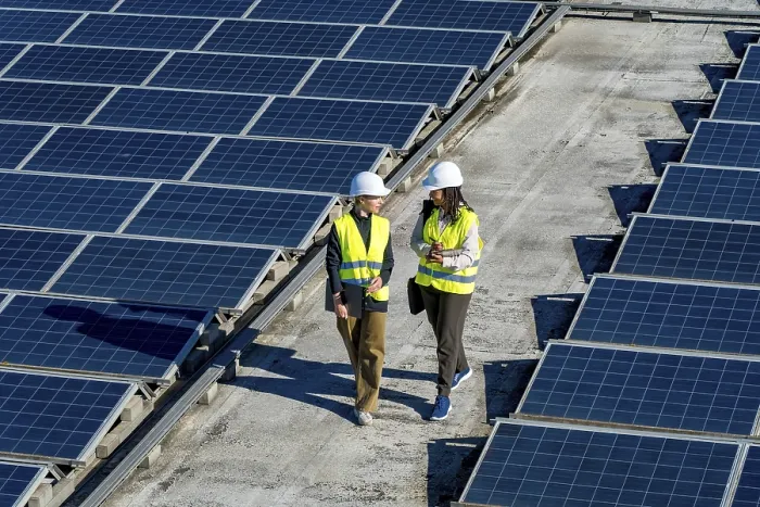 Framed Print : Two women engineers wearing hard hats and high visibility vests walking