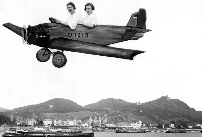 Framed Print : Two women fly into a cardboard plane over the Rhine