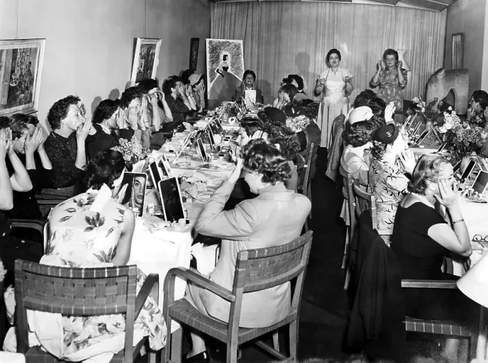 Framed Print : Women learn how to apply make-up