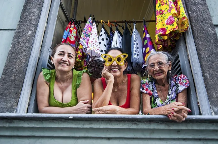 Framed Print : Three women looking out of a window in Lapa
