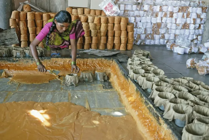 Framed Print : Women putting jaggery in moulds