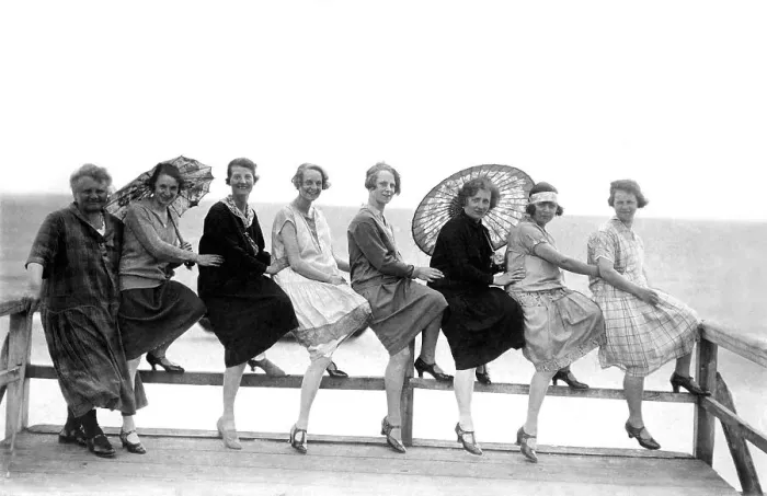 Framed Print : Eight women by the sea, two with parasols