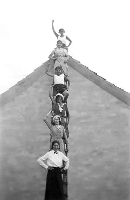 Framed Print : Six women standing on a ladder in front of a house waving Framed Print : Six women standing on a ladder in front of a house waving