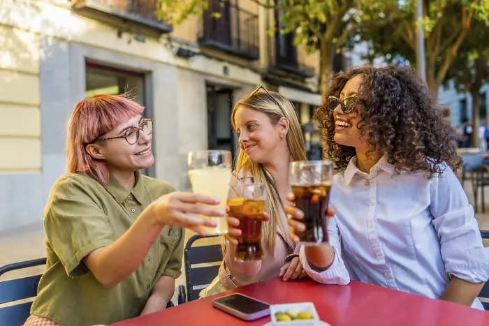 Framed Print : Women toasting and celebrating together sitting on an outdoor bar during sunset in the city Framed Print : Women toasting and celebrating together sitting on an outdoor bar during sunset in the city