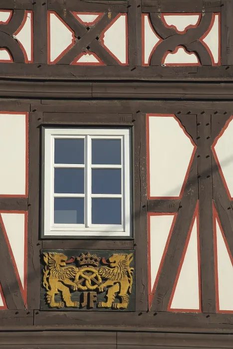 Framed Print : Wood carving with lion figures and pretzel on half-timbered house Framed Print : Wood carving with lion figures and pretzel on half-timbered house