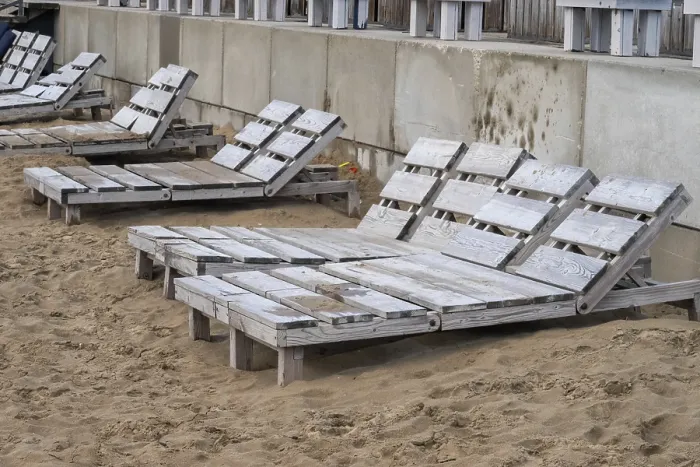 Framed Print : Empty wooden beach chairs sit on a sandy shore